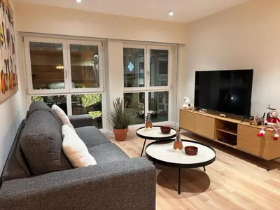 a living room with a couch and a flat screen tv at LAS TERRAZAS I Lujo frente a la plaza de Santa Eufemia in Ourense