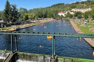 a group of people swimming in a river at El Rincón de la Mimosa in Vega de Espinareda