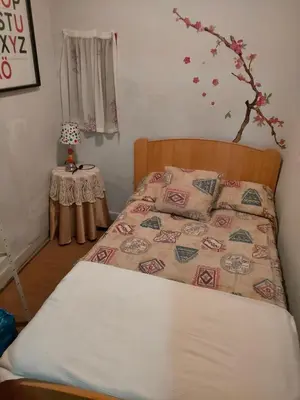 a bedroom with a bed and a table at Apartamento Casco Viejo in Ourense