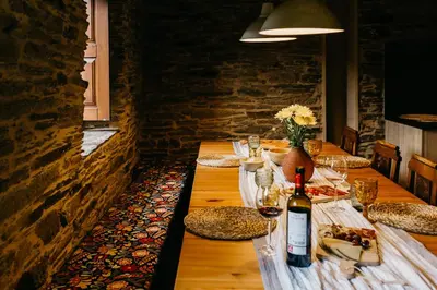 a long table with a bottle of wine on it at Casas de Outeiro in Samos