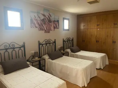 a room with two beds with white sheets at Hotel Rural El Molinero de Santa Colomba de Somoza in Santa Colomba de Somoza