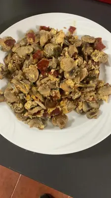 a pile of food on a white plate on a table at Hotel Rural El Molinero de Santa Colomba de Somoza in Santa Colomba de Somoza
