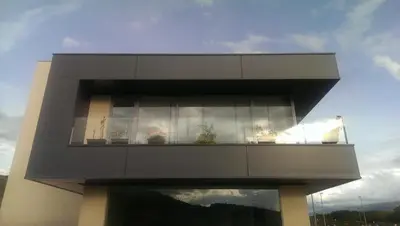 a building with a window with potted plants on it at NRuta Ponferrada in Bembibre