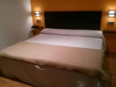 a bedroom with a large bed with white sheets at NRuta Ponferrada in Bembibre