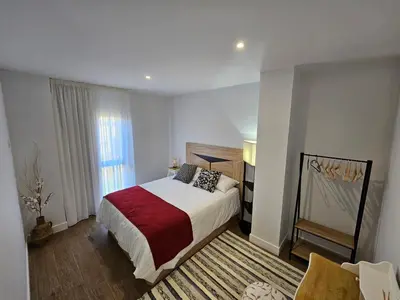 a bedroom with a large bed and a window at La Cochorla in Páramo del Sil