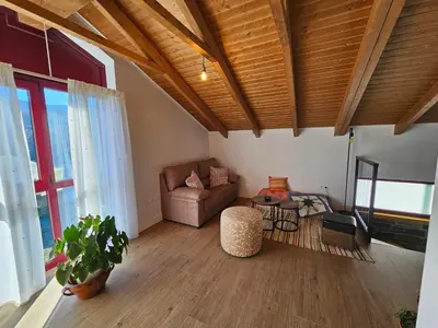 a living room with a couch and a chair at La Cochorla in Páramo del Sil