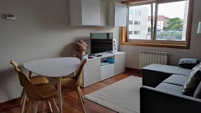 a small living room with a table and a couch at Wanderlust Bastiagueiro in Perillo