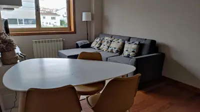 a living room with a table and a couch at Wanderlust Bastiagueiro in Perillo
