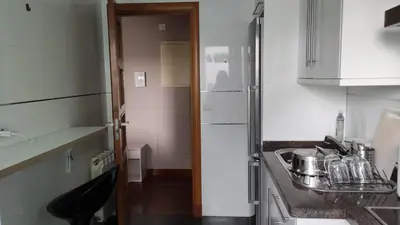 a small kitchen with a sink and a refrigerator at Wanderlust Bastiagueiro in Perillo