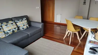 a living room with a couch and a table at Wanderlust Bastiagueiro in Perillo
