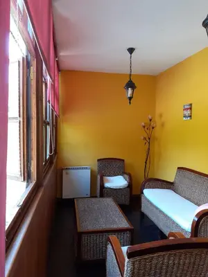 a room with chairs and a bed and a window at OSO3 in Pola de Somiedo