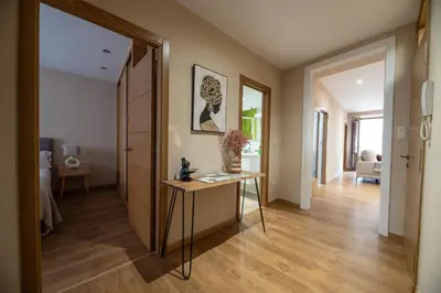 a hallway with a table in the middle of a room at EREA apartamentos turísticos in Monforte de Lemos