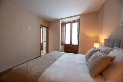 a bedroom with a large bed and a window at EREA apartamentos turísticos in Monforte de Lemos
