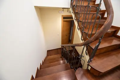 a spiral staircase in a building with wooden floors at SACRA apartamentos turísticos in Monforte de Lemos