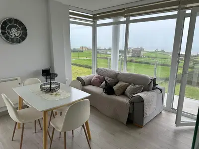 a living room with a couch and a table at DUNAS DE LLAS in Foz