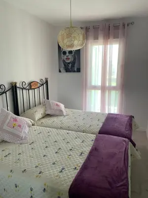 a bedroom with two beds and a skull picture on the wall at DUNAS DE LLAS in Foz