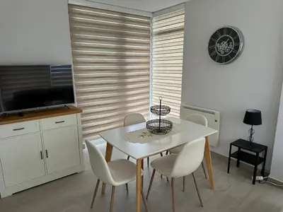 a dining room with a white table and chairs at DUNAS DE LLAS in Foz