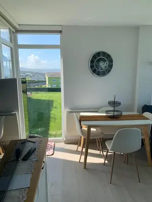 a dining room with a table and a window at DUNAS DE LLAS in Foz