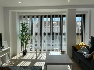 a living room with a couch and a table at Apartamentos Ares Rentals in Ares