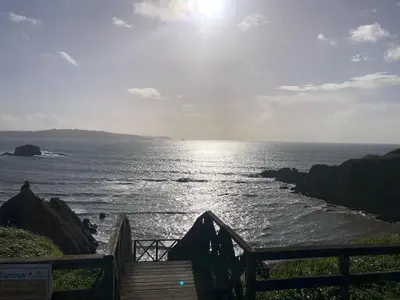 a view of the ocean from a wooden bridge at Apartamentos Ares Rentals in Ares