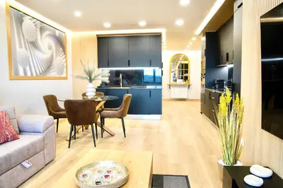 a living room and kitchen with a couch and a table at Lucus Skyline & Terrace by Lugo Collection in Lugo