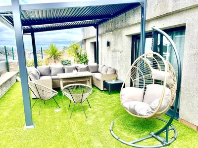 a patio with a couch and chairs on the grass at Lucus Skyline & Terrace by Lugo Collection in Lugo