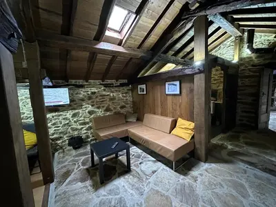a living room with a couch and a table at Ca Manín in Tineo