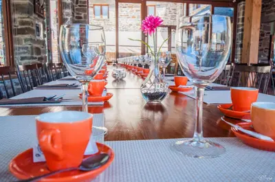 a long table with wine glasses on a table at Hotel Rural La Bolera in Robles de Laciana