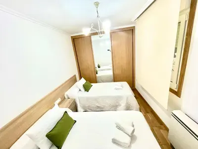 a room with two beds and a mirror at PARAISO in Viveiro
