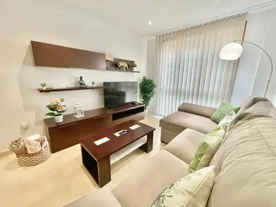 a living room with a couch and a tv at PARAISO in Viveiro