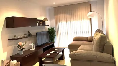 a living room with a couch and a tv at PARAISO in Viveiro