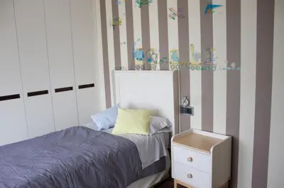 a small bedroom with a bed and a dresser at Ático en el camino de Santiago in Sarria