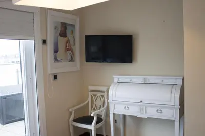 a room with a dresser and a tv on the wall at Ático en el camino de Santiago in Sarria