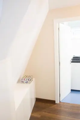a white staircase in a room with a stair case at Ático en el camino de Santiago in Sarria