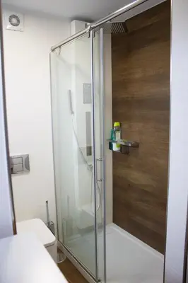a shower with a glass door in a bathroom at Ático en el camino de Santiago in Sarria