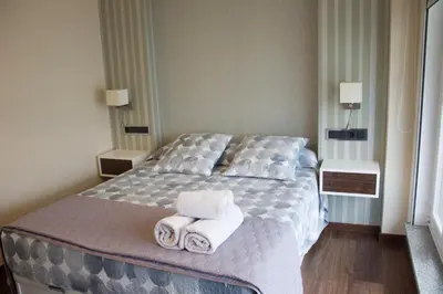 a bedroom with a bed with towels on it at Ático en el camino de Santiago in Sarria
