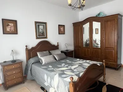 a bedroom with a bed and a dresser and mirror at Casa Camiño do Eume in A Coruña