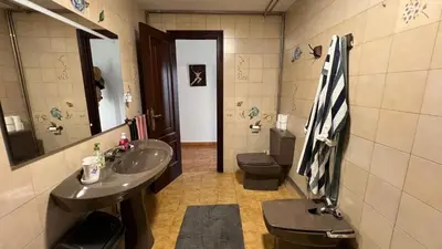 a bathroom with a sink and a toilet and a mirror at Casa Camiño do Eume in A Coruña