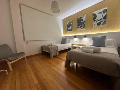 a bedroom with a bed with two towels on it at HOME GV35 By Oktheway in Sarria