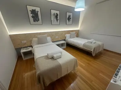 a bathroom with a sink and a toilet and a mirror at HOME GV35 By Oktheway in Sarria