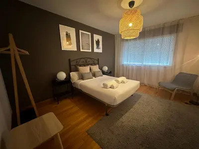 a bedroom with a large white bed with towels on it at HOME GV35 By Oktheway in Sarria