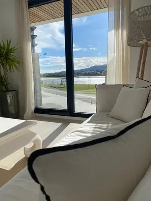 a white couch in a room with a large window at APARTAMENTO A ESTRENAR en FOZ COFRADIA DELUXE in Foz