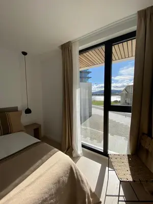 a bedroom with a bed and a large window at APARTAMENTO A ESTRENAR en FOZ COFRADIA DELUXE in Foz