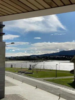 a view of a body of water with two benches at APARTAMENTO A ESTRENAR en FOZ COFRADIA DELUXE in Foz