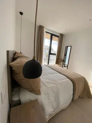 a bedroom with a bed with a large window at APARTAMENTO A ESTRENAR en FOZ COFRADIA DELUXE in Foz