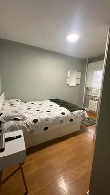 a bedroom with a bed and a wooden floor at Apartamento Santiago in Santiago de Compostela