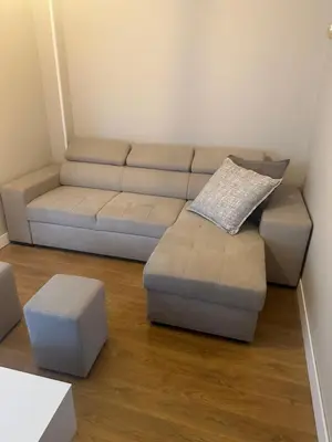 a living room with a couch and ottoman at Apartamento Santiago in Santiago de Compostela
