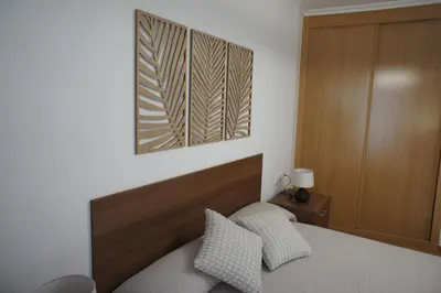 a bedroom with a bed and a picture on the wall at Alojamientos Viveiro - Playa de Covas I in Viveiro