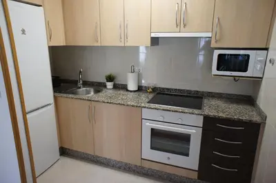 a small kitchen with a sink and a microwave at Alojamientos Viveiro - Playa de Covas I in Viveiro