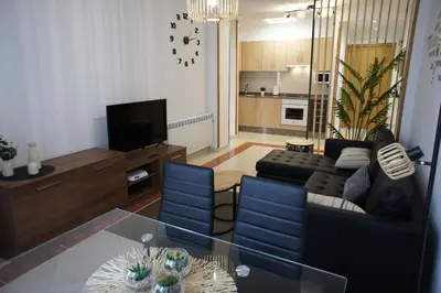 a living room with a couch and a table at Alojamientos Viveiro - Playa de Covas I in Viveiro
